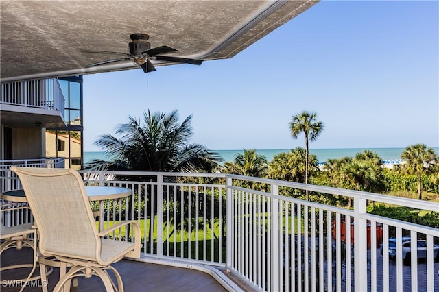 balcony featuring a water view and ceiling fan