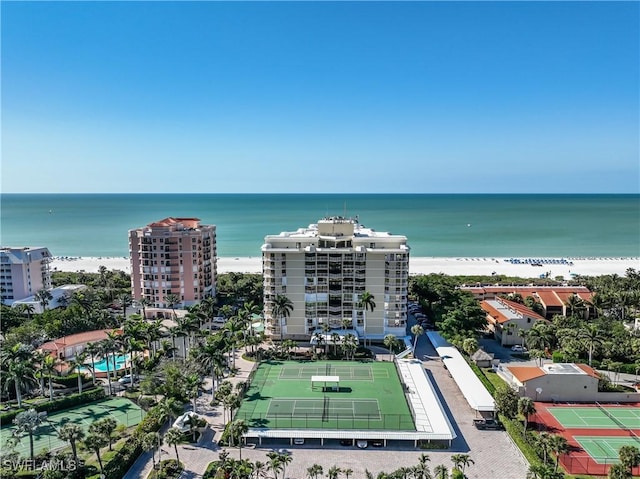 birds eye view of property with a water view and a view of the beach