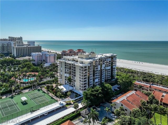 birds eye view of property featuring a water view and a beach view