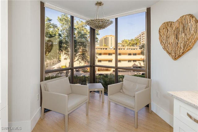 sitting room featuring light hardwood / wood-style flooring and floor to ceiling windows