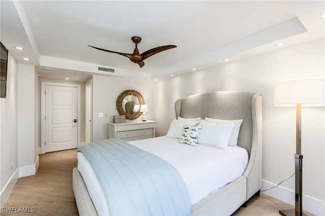 bedroom featuring ceiling fan and a tray ceiling