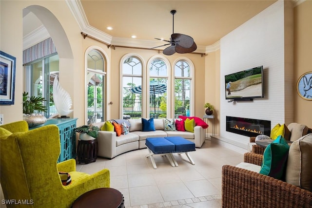 sunroom / solarium with ceiling fan and a fireplace