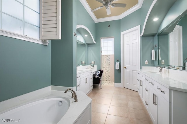 bathroom featuring ceiling fan, tile patterned flooring, ornamental molding, a washtub, and vanity