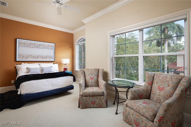 carpeted bedroom with ceiling fan, multiple windows, and ornamental molding