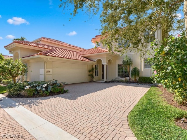 mediterranean / spanish-style home with a garage