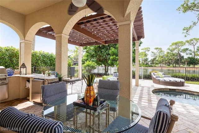 view of patio featuring a bar and exterior kitchen