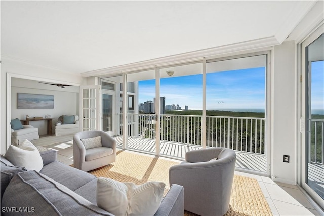 sunroom / solarium featuring ceiling fan and plenty of natural light