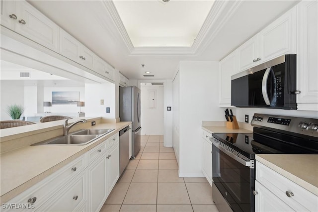 kitchen featuring sink, a tray ceiling, light tile patterned flooring, white cabinetry, and stainless steel appliances