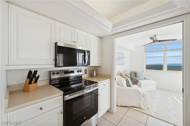 kitchen featuring ceiling fan, ornamental molding, appliances with stainless steel finishes, light tile patterned flooring, and white cabinetry