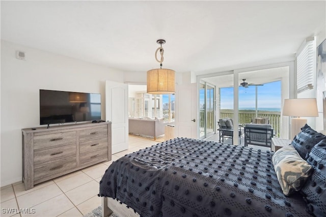 tiled bedroom with access to outside, a water view, and a wall of windows