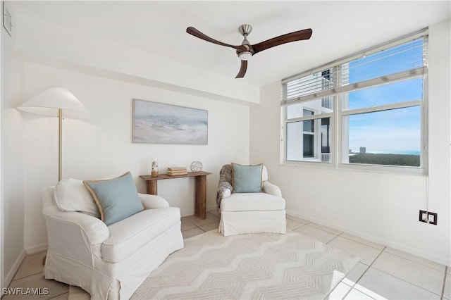 sitting room featuring light tile patterned floors and ceiling fan