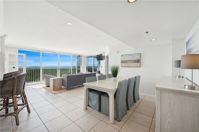 dining area with light tile patterned flooring and a wall of windows