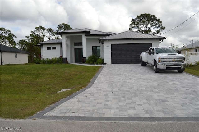 view of front of property featuring a garage and a front yard