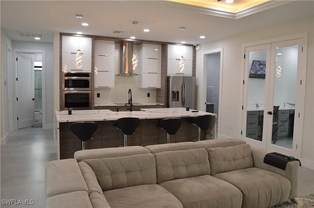 living room featuring french doors and sink