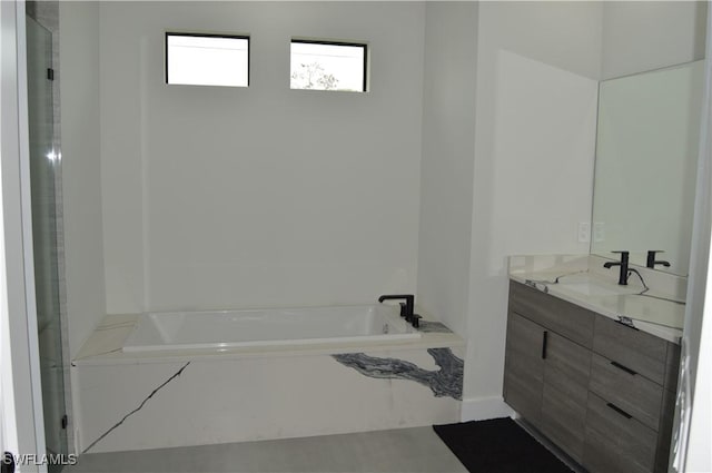 bathroom featuring a tub and vanity