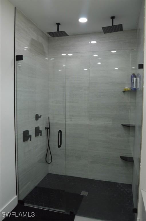 bathroom featuring a shower with door