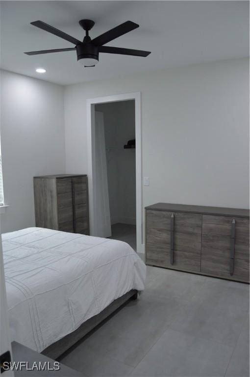 bedroom featuring ceiling fan, a spacious closet, and a closet