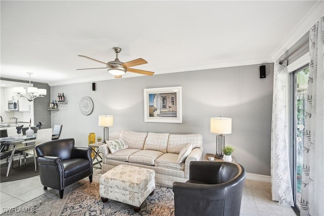 tiled living room with ceiling fan with notable chandelier and crown molding