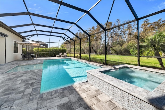 view of pool with glass enclosure, an in ground hot tub, and a patio