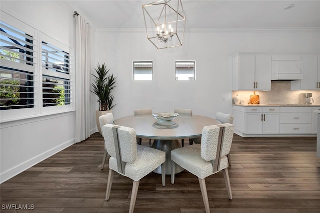 dining room featuring a chandelier, crown molding, and dark wood-type flooring