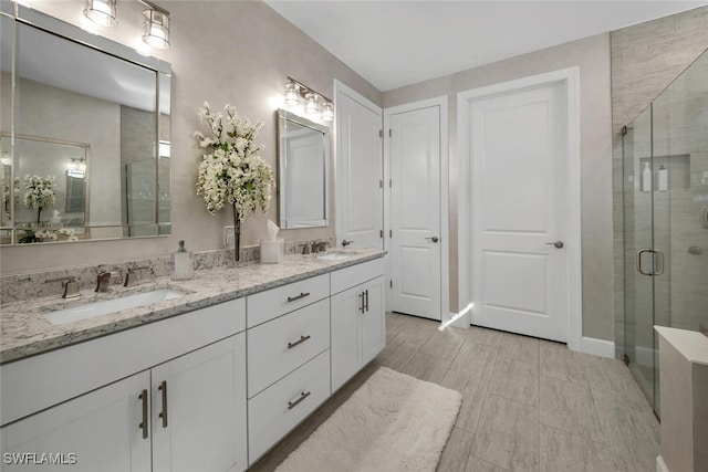 bathroom featuring vanity and a shower with shower door