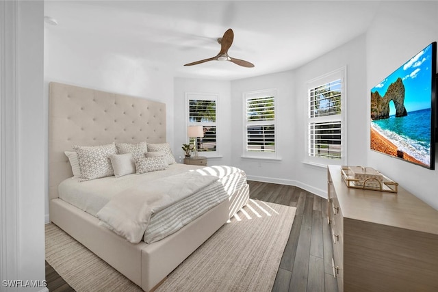 bedroom with ceiling fan and dark hardwood / wood-style flooring