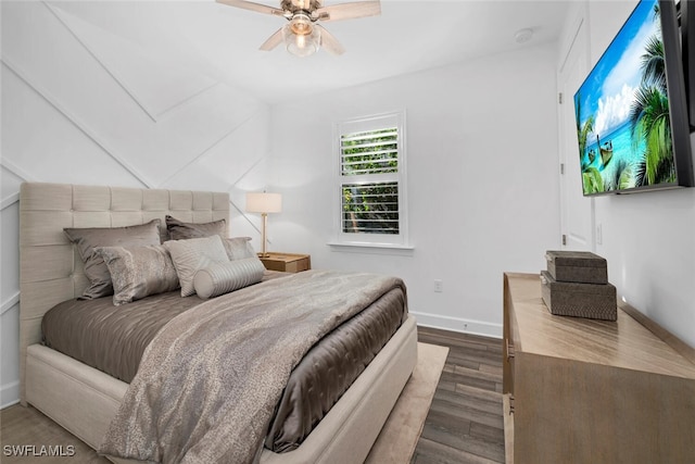 bedroom with dark hardwood / wood-style flooring and ceiling fan