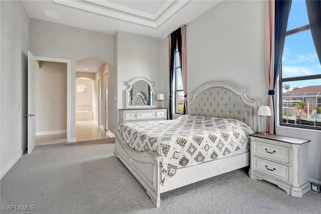 carpeted bedroom featuring connected bathroom