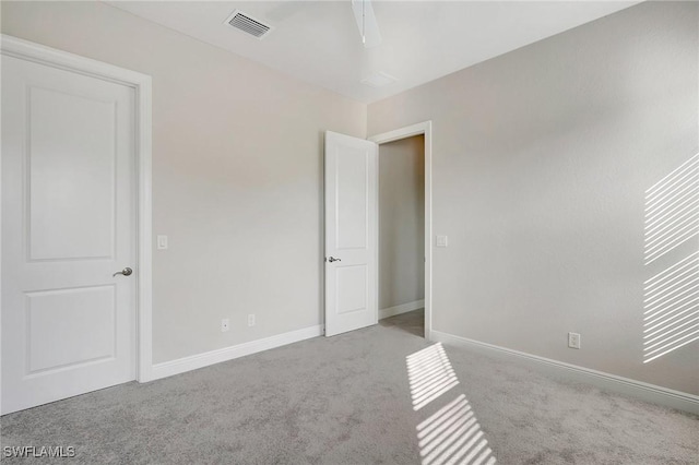 unfurnished bedroom featuring ceiling fan and light carpet