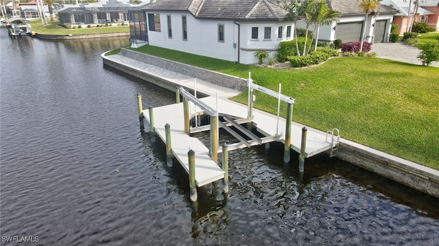 view of dock featuring a water view and a yard