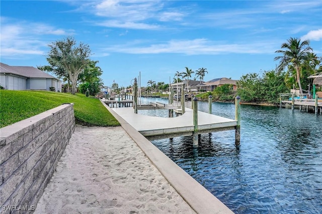 view of dock featuring a yard and a water view