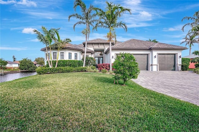 view of front facade featuring a garage and a front lawn