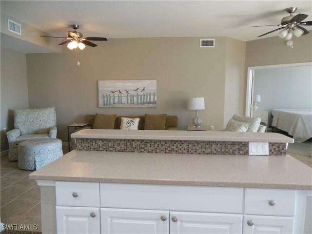 interior space featuring ceiling fan and light tile patterned floors