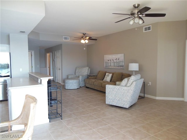 tiled living room with ceiling fan