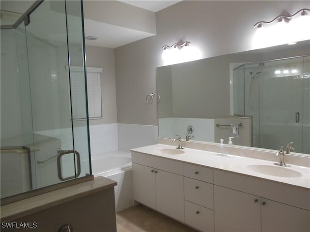 bathroom featuring tile patterned floors, vanity, and shower with separate bathtub