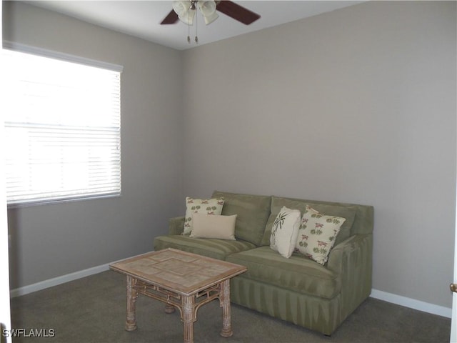 carpeted living room with ceiling fan and plenty of natural light