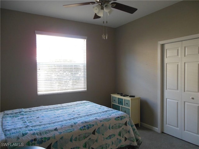 carpeted bedroom with a closet and ceiling fan