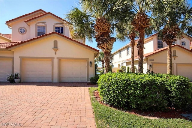 16590 Crownsbury Way Unit 102, Fort Myers, FL 33908 - mediterranean / spanish house featuring a tiled roof, decorative driveway, and stucco siding