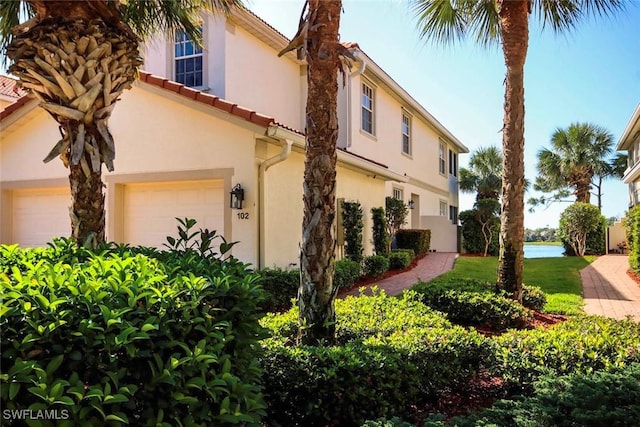 16590 Crownsbury Way Unit 102, Fort Myers, FL 33908 - exterior space with a tile roof and stucco siding
