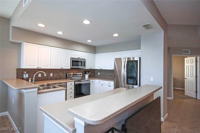 16590 Crownsbury Way Unit 102, Fort Myers, FL 33908 - kitchen featuring backsplash, a sink, appliances with stainless steel finishes, and visible vents