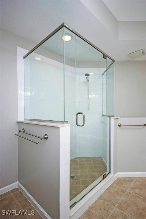 16590 Crownsbury Way Unit 102, Fort Myers, FL 33908 - bathroom featuring baseboards, visible vents, a stall shower, and tile patterned floors