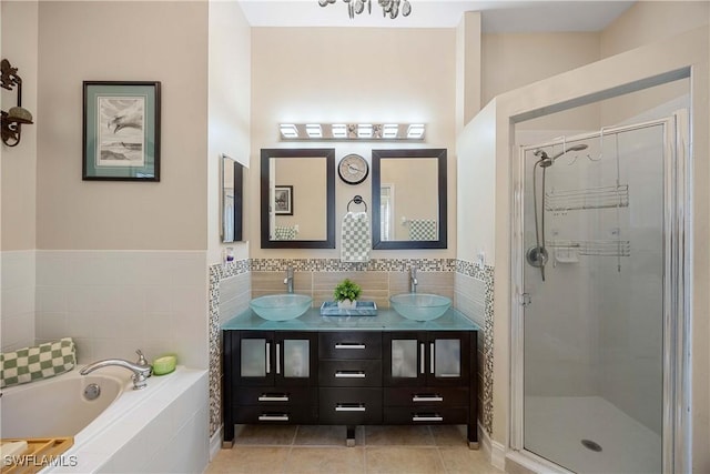 bathroom featuring tile patterned flooring, vanity, and shower with separate bathtub