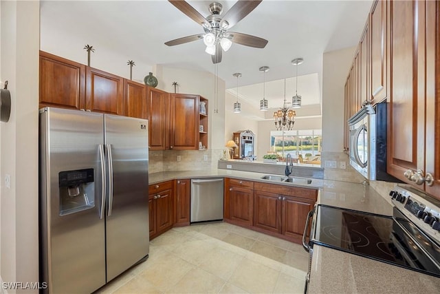 kitchen featuring backsplash, ceiling fan with notable chandelier, sink, decorative light fixtures, and stainless steel appliances