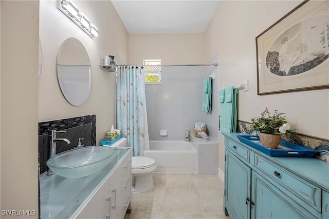 full bathroom with tile patterned floors, shower / tub combo with curtain, vanity, and toilet