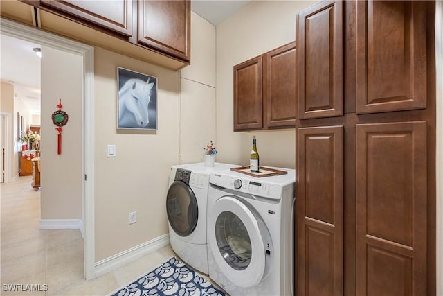 laundry area featuring washer and dryer and cabinets