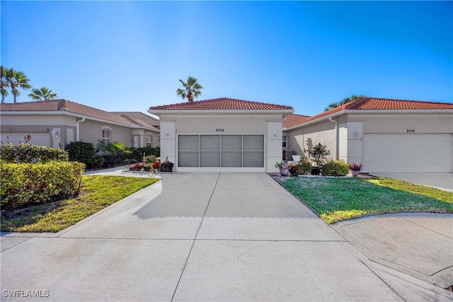 mediterranean / spanish-style house with a front yard and a garage