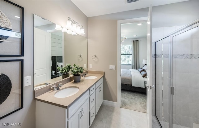 bathroom featuring tile patterned flooring, vanity, and a shower with shower door