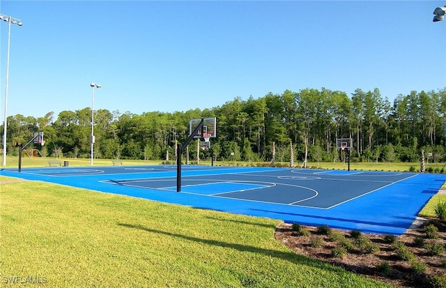 view of basketball court featuring a lawn