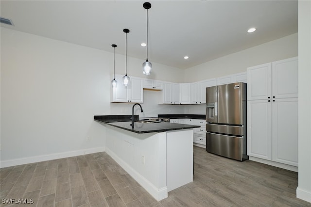 kitchen featuring pendant lighting, white cabinets, sink, kitchen peninsula, and stainless steel fridge with ice dispenser