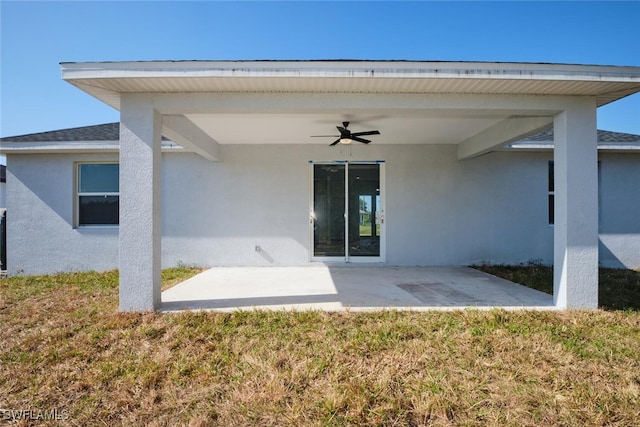 back of house featuring a patio area, ceiling fan, and a yard